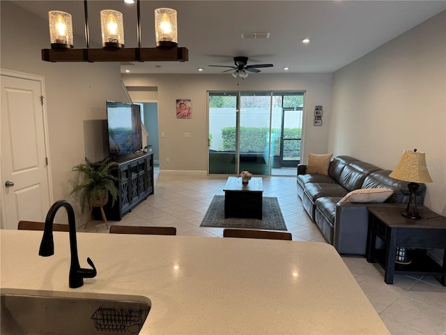 living area featuring recessed lighting, light tile patterned flooring, and visible vents