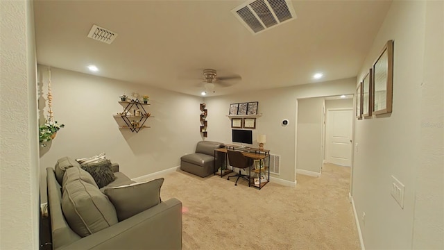 home office with baseboards, visible vents, and light colored carpet