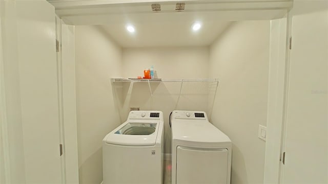 clothes washing area featuring recessed lighting, laundry area, and washing machine and clothes dryer