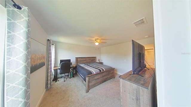 bedroom featuring baseboards, ceiling fan, visible vents, and light colored carpet