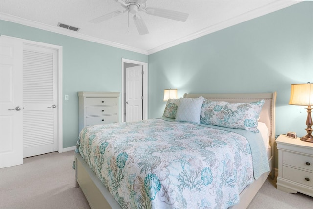 carpeted bedroom with ceiling fan and ornamental molding