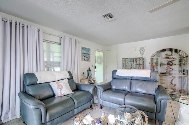 tiled living room with a textured ceiling