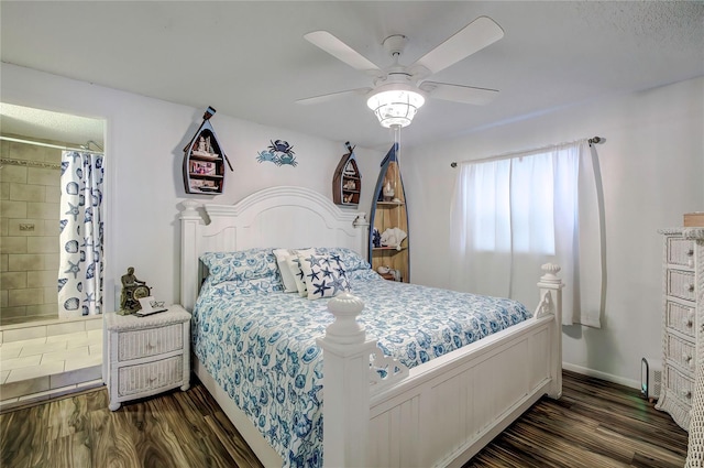 bedroom with connected bathroom, dark hardwood / wood-style flooring, and ceiling fan