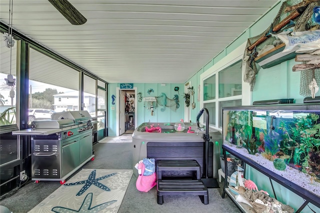 sunroom with a hot tub