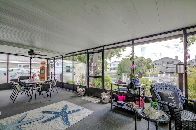 sunroom featuring ceiling fan