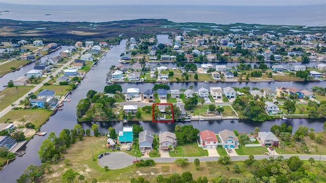 aerial perspective of suburban area with a nearby body of water and property parcel outlined