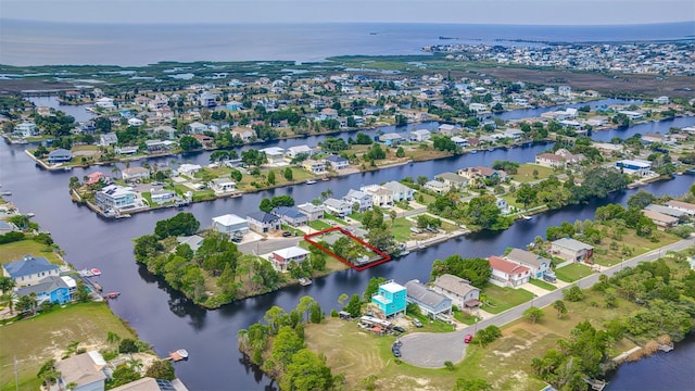 aerial perspective of suburban area with property parcel outlined and a nearby body of water