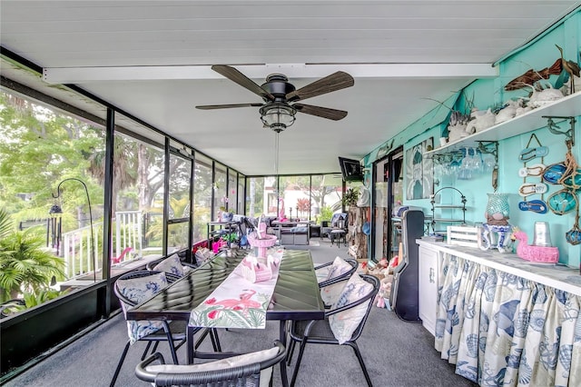 sunroom featuring ceiling fan