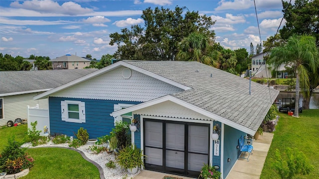 view of front of home with a garage and a front lawn