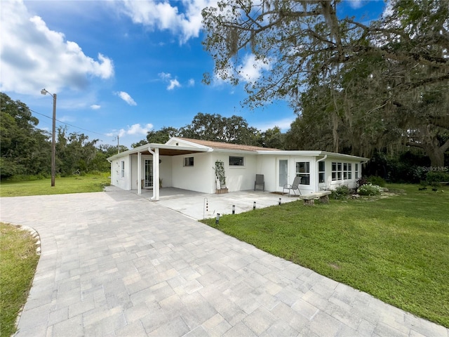 view of front facade with a front lawn and a carport