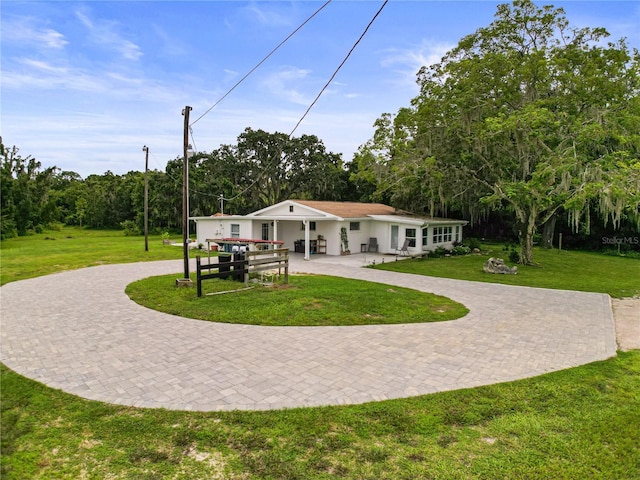 back of property featuring a lawn