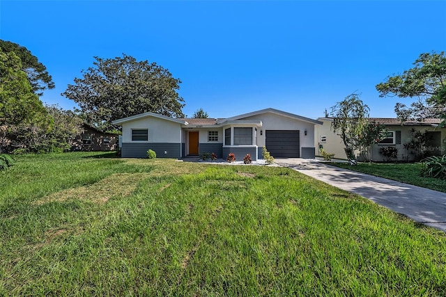 ranch-style home with a garage and a front lawn