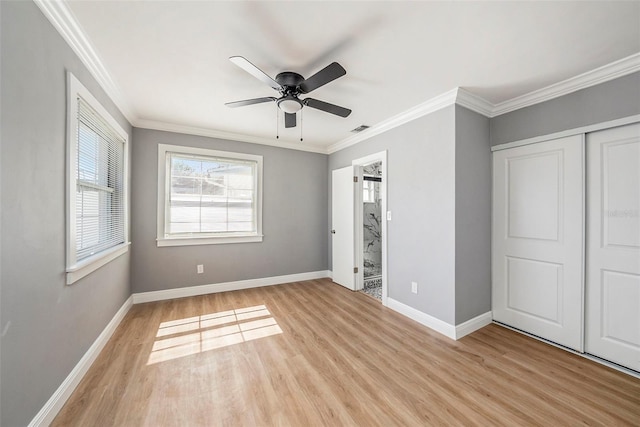 unfurnished bedroom with a closet, ceiling fan, crown molding, and light hardwood / wood-style flooring