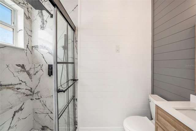 bathroom featuring walk in shower, toilet, and vanity