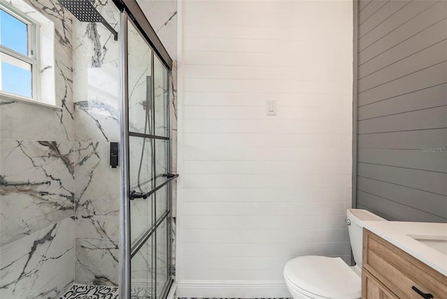 bathroom featuring vanity, toilet, an enclosed shower, and wood walls