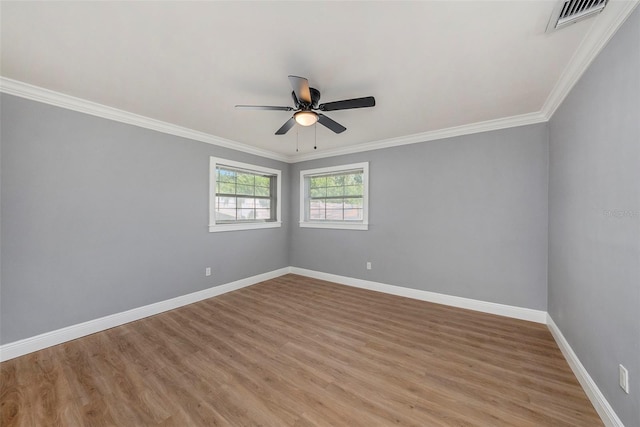 spare room with light wood-type flooring, ornamental molding, and ceiling fan