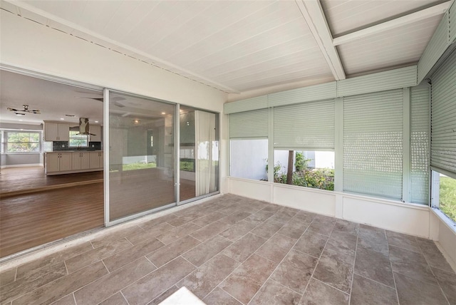 unfurnished sunroom with wood ceiling and beamed ceiling