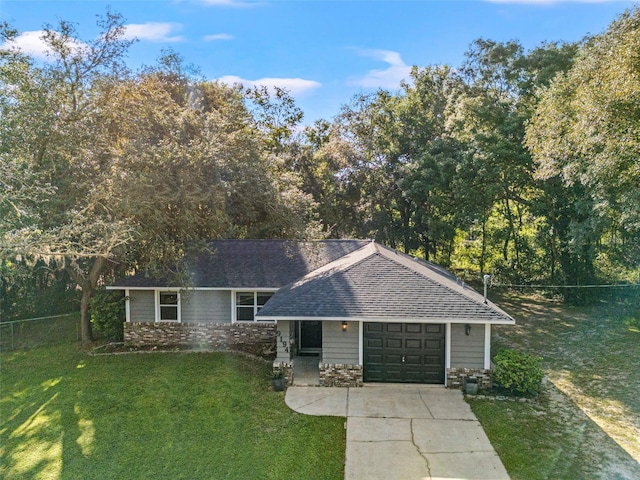 single story home featuring a front yard and a garage