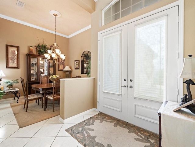 tiled foyer entrance with crown molding, french doors, a chandelier, and a wealth of natural light