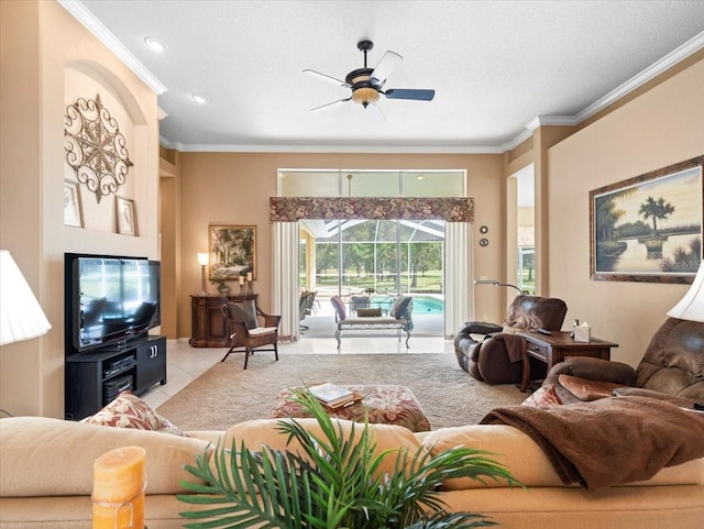 living room featuring ceiling fan, light tile patterned floors, crown molding, and a textured ceiling