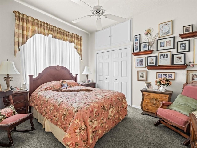 bedroom with ceiling fan, dark colored carpet, and a closet