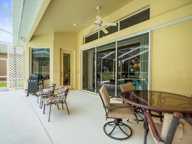 view of patio with a grill and ceiling fan