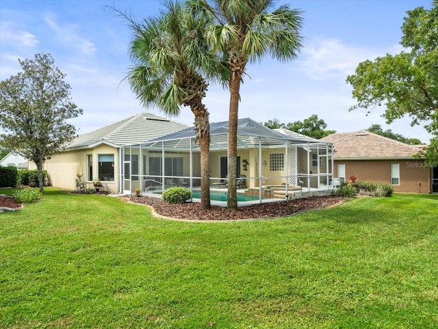 back of house featuring a lanai, a swimming pool, and a lawn