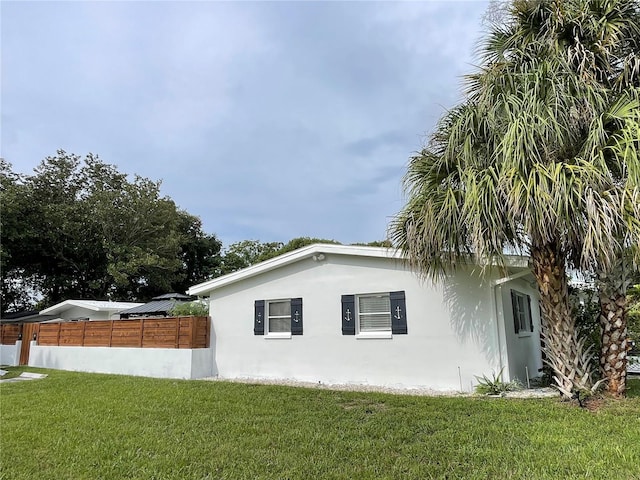 view of home's exterior featuring a lawn