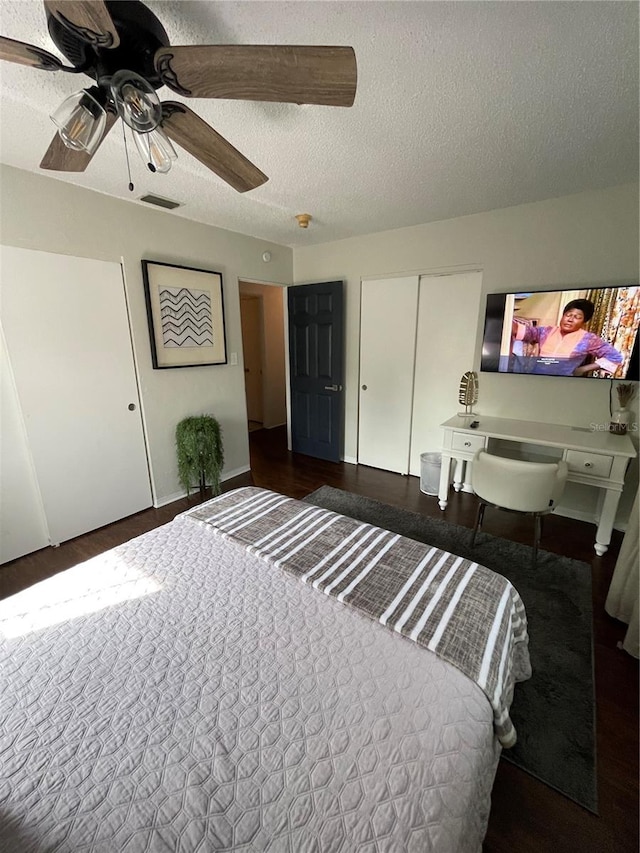 bedroom with dark hardwood / wood-style flooring, a closet, ceiling fan, and a textured ceiling