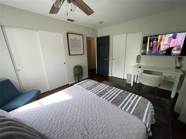 bedroom with a textured ceiling, dark hardwood / wood-style floors, and ceiling fan