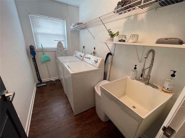 clothes washing area with sink, dark wood-type flooring, and independent washer and dryer