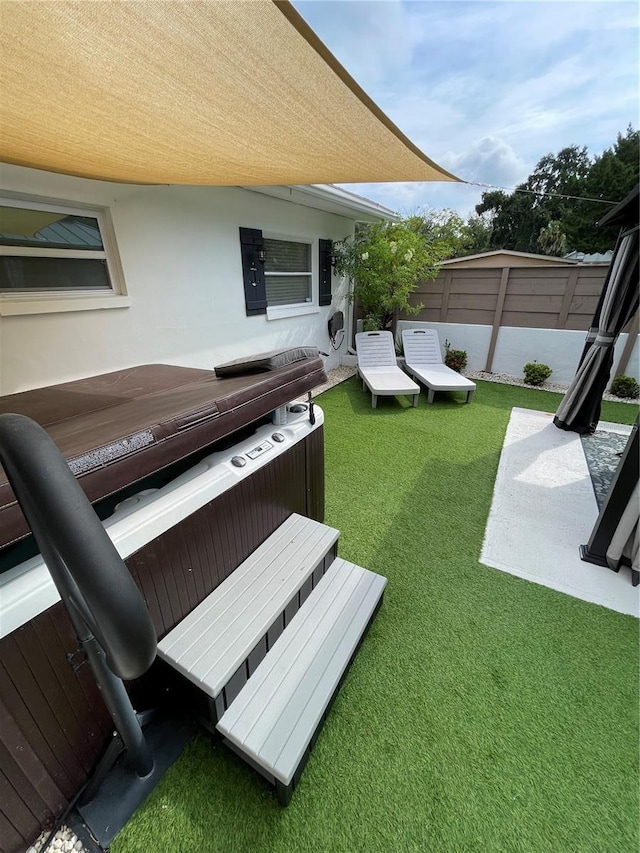 view of yard with a hot tub and a patio