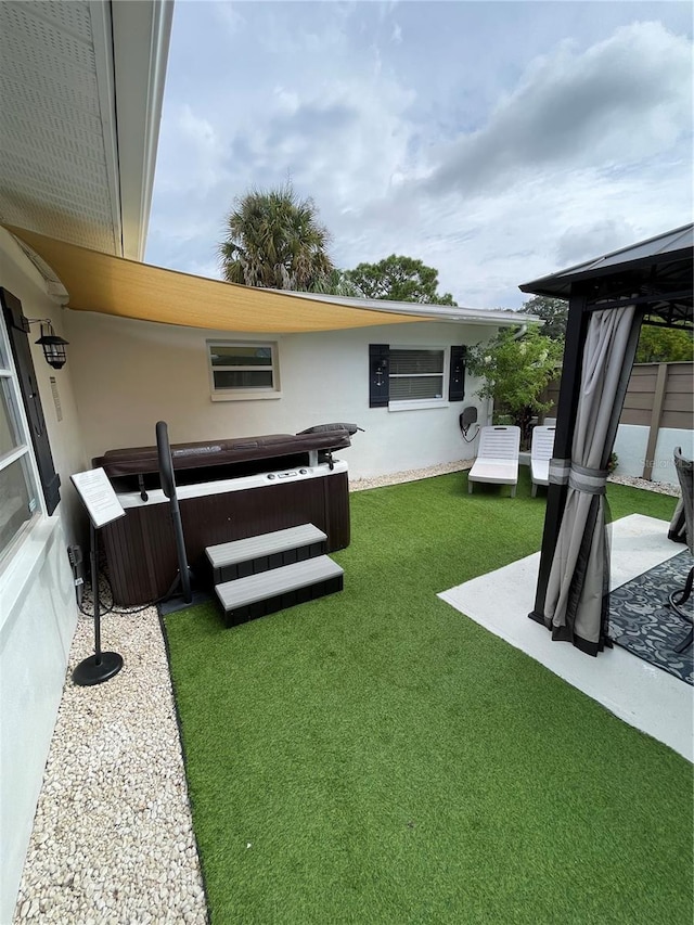 view of yard with a patio and a jacuzzi