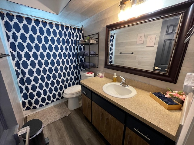 bathroom with curtained shower, hardwood / wood-style floors, vanity, and toilet