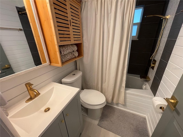 full bathroom featuring shower / bath combination with curtain, vanity, and toilet