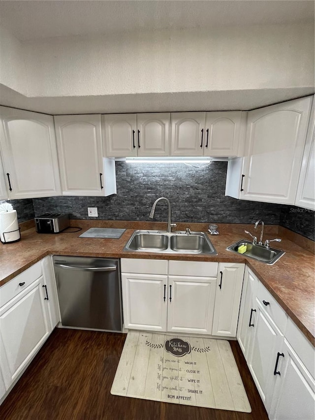 kitchen featuring dishwasher, dark hardwood / wood-style floors, sink, and white cabinetry