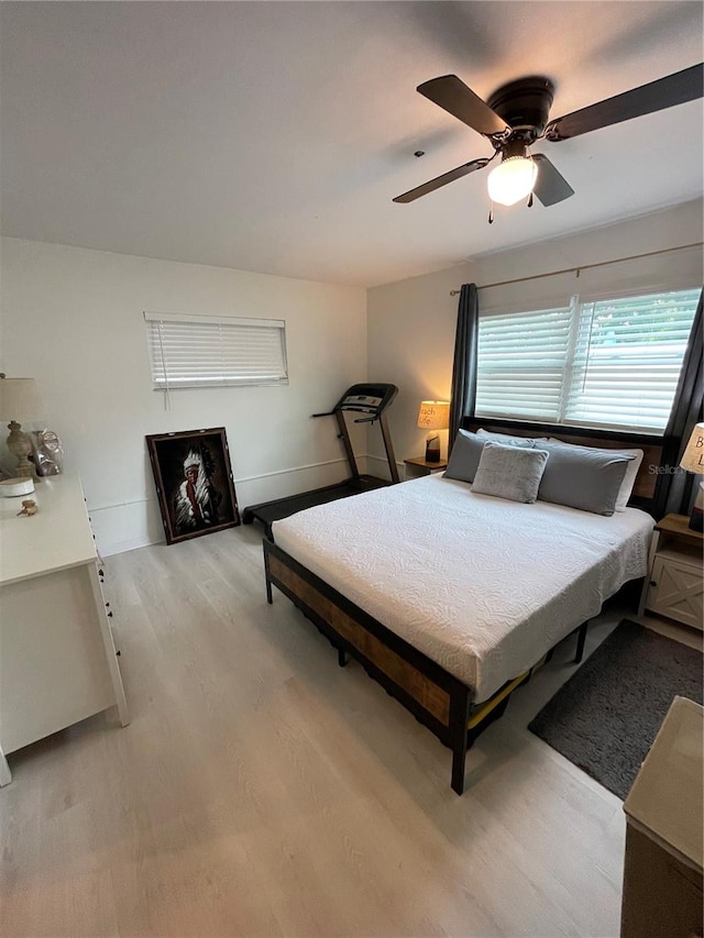 bedroom with light hardwood / wood-style floors and ceiling fan