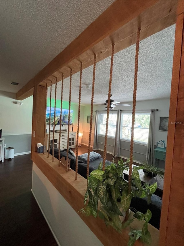 interior space featuring a textured ceiling and dark wood-type flooring