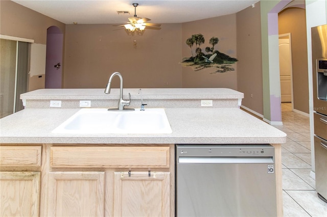 kitchen with light brown cabinets, light tile patterned floors, ceiling fan, stainless steel dishwasher, and sink