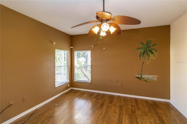 spare room with hardwood / wood-style floors and ceiling fan