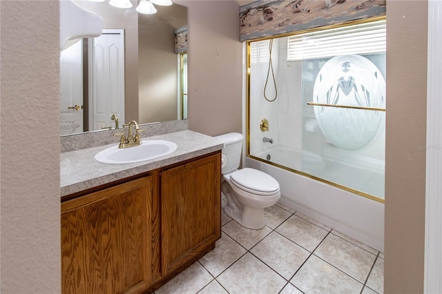 full bathroom featuring combined bath / shower with glass door, vanity, toilet, and tile patterned floors