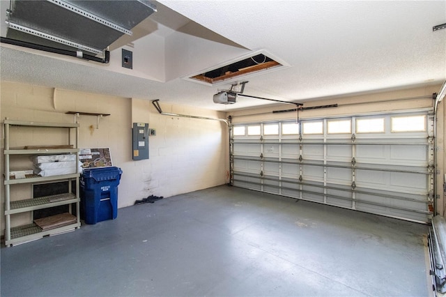 garage featuring a garage door opener and electric panel