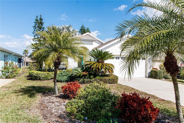 view of front of home with a garage and a front yard