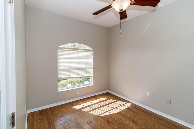 unfurnished room with dark hardwood / wood-style flooring and ceiling fan