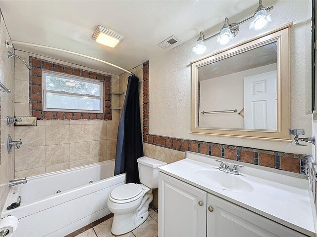 full bathroom featuring shower / bathtub combination with curtain, tile patterned floors, vanity, and toilet