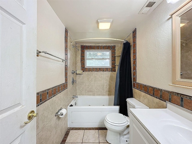 full bathroom featuring vanity, toilet, shower / bath combo, tile walls, and tile patterned flooring