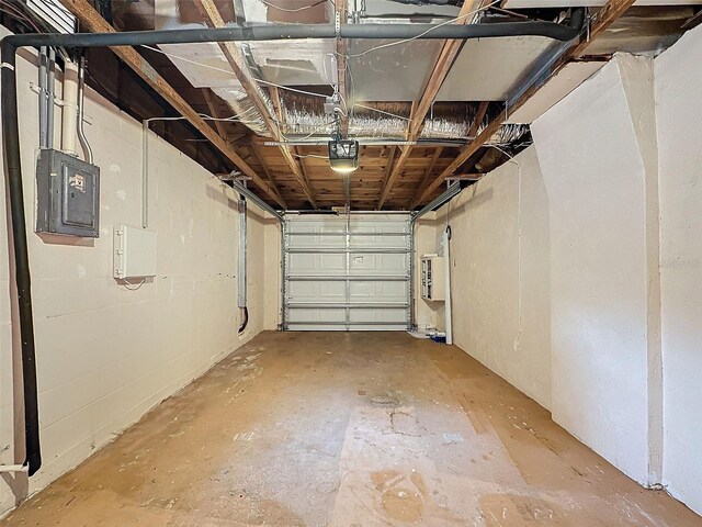 garage featuring a garage door opener and electric panel