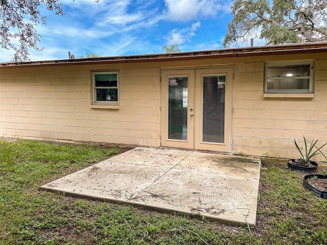 view of exterior entry with a patio