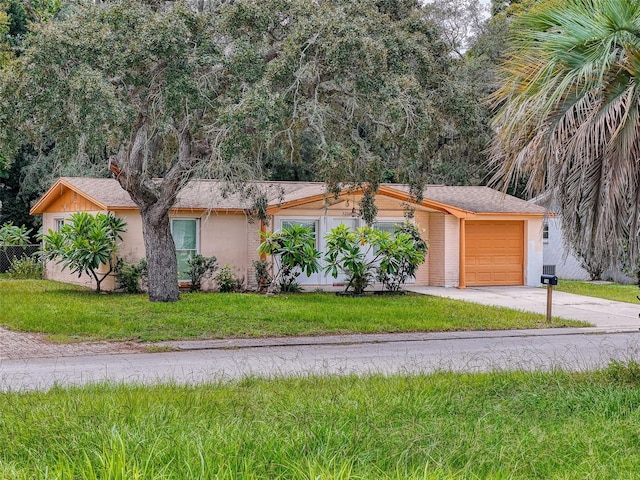 view of front of property featuring a garage and a front lawn