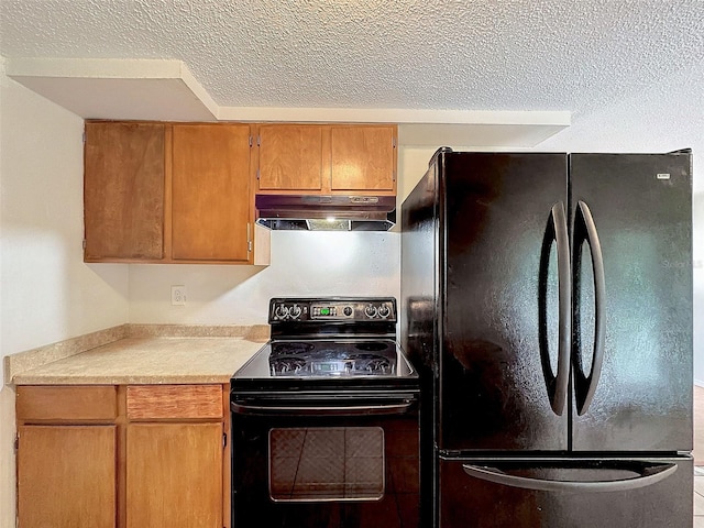 7206 Ashwood Dr, Port Richey, FL 34668 - kitchen with black appliances, under cabinet range hood, a textured ceiling, light countertops, and brown cabinetry